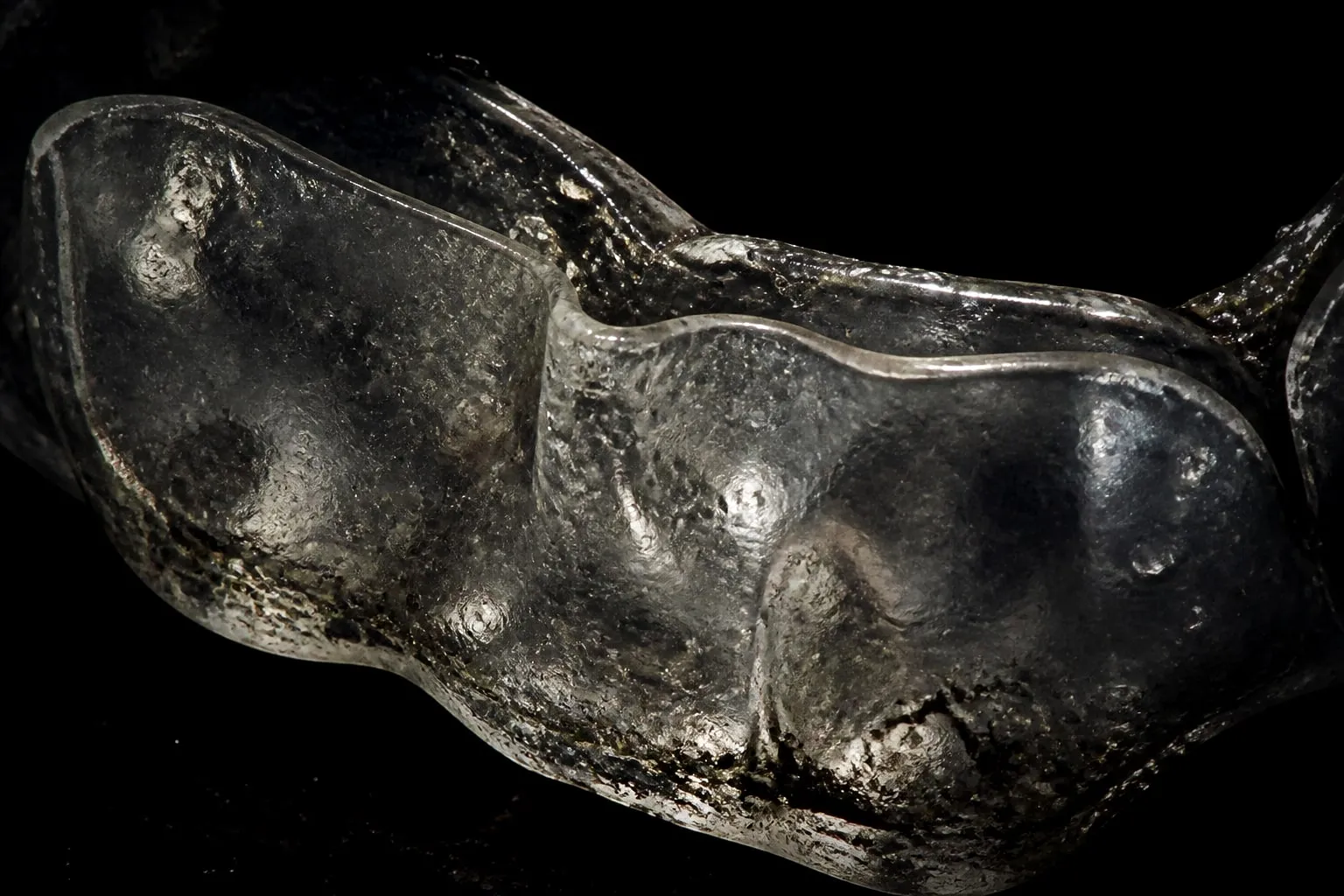 Editorial illustration: clear plastic mouthguard close up