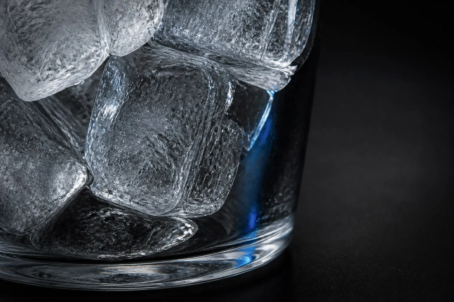 Editorial illustration: ice cubes in glass macro close up
